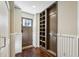 Hallway with wood-look floors and storage niche with hooks and storage shelves at 1696 N Pelham Ne Rd, Atlanta, GA 30324