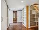 Hallway with sliding barn doors, built-in shelving, and staircase at 1696 N Pelham Ne Rd, Atlanta, GA 30324