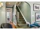 Charming foyer featuring beautiful olive green walls and dark wood staircase at 1696 N Pelham Ne Rd, Atlanta, GA 30324