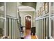 Inviting hallway with hardwood floors, paneled walls, and arched doorways at 1696 N Pelham Ne Rd, Atlanta, GA 30324