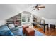 Inviting home office with custom built-in shelving, a cozy blue sofa, and natural lighting at 1696 N Pelham Ne Rd, Atlanta, GA 30324