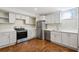 Modern kitchen featuring white cabinets, stainless steel appliances and concrete floors at 1696 N Pelham Ne Rd, Atlanta, GA 30324