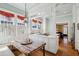 Bright kitchen featuring a rustic wood table, gas range, and white cabinets at 1696 N Pelham Ne Rd, Atlanta, GA 30324