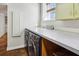 A laundry room with a modern washer and dryer and a white countertop at 1696 N Pelham Ne Rd, Atlanta, GA 30324