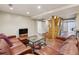 Cozy living room with leather seating, decorative rug, and view of staircase at 1696 N Pelham Ne Rd, Atlanta, GA 30324