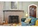 Cozy living room with a fireplace, comfortable seating, and stylish decor at 1696 N Pelham Ne Rd, Atlanta, GA 30324