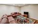 Living room with leather seating, glass table, rug, and whitewashed brick wall at 1696 N Pelham Ne Rd, Atlanta, GA 30324