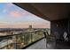 Inviting balcony with outdoor dining set, showcasing stunning city vistas at dusk at 3344 Peachtree Ne Rd # 3305, Atlanta, GA 30326