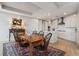 Dining room connects to a modern kitchen, featuring white cabinets and stainless-steel appliances at 3344 Peachtree Ne Rd # 3305, Atlanta, GA 30326