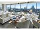 Bright living room with floor-to-ceiling windows offering panoramic city views and stylish furnishings at 3344 Peachtree Ne Rd # 3305, Atlanta, GA 30326