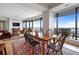 Open-concept living and dining area with a rustic dining table, balcony access, and comfortable seating at 3344 Peachtree Ne Rd # 3305, Atlanta, GA 30326