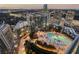 High-angle view of the outdoor pool surrounded by lights and lush greenery at 3344 Peachtree Ne Rd # 3305, Atlanta, GA 30326