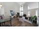 Bright living room with high ceilings, fireplace, large windows, and hardwood flooring at 4403 Thorngate Ln, Acworth, GA 30101