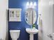 Beautiful bathroom with blue walls, cabinet and pedestal sink at 4883 Seldon Se Way, Smyrna, GA 30080