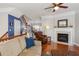 Cozy living room with a fireplace, plush seating, and hardwood floors, perfect for relaxation at 4883 Seldon Se Way, Smyrna, GA 30080