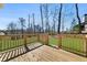 Enjoy a wooden deck overlooking the lush, green backyard and surrounding trees at 939 Whistler Ln, Canton, GA 30114