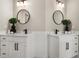 Modern bathroom featuring double sink vanities, round mirrors, and sleek matte black hardware at 939 Whistler Ln, Canton, GA 30114