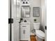 Compact powder room featuring modern fixtures, a pedestal sink, and a toilet at 939 Whistler Ln, Canton, GA 30114