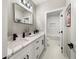 Stylish bathroom with a white vanity, marble countertop, and a framed mirror at 939 Whistler Ln, Canton, GA 30114