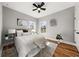 Light-filled bedroom with hardwood floors, ceiling fan, and a plush rug at 939 Whistler Ln, Canton, GA 30114