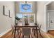 Sunlit dining room with hardwood floors, modern lighting, and a view of the outdoors at 939 Whistler Ln, Canton, GA 30114