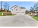 Newly constructed home featuring a two-car garage, neutral siding, and level driveway at 939 Whistler Ln, Canton, GA 30114