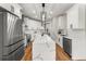 Contemporary kitchen featuring white cabinets, stainless steel appliances, and a spacious island at 939 Whistler Ln, Canton, GA 30114