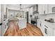 Modern kitchen featuring white cabinetry, stainless steel appliances, and a quartz countertop island at 939 Whistler Ln, Canton, GA 30114