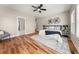 Serene main bedroom with hardwood floors, natural light, and a decorative ceiling fan at 939 Whistler Ln, Canton, GA 30114