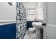 Bathroom with pedestal sink, toilet and shower with patterned curtain at 1547 Melrose Sw Dr, Atlanta, GA 30310