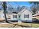 Charming white cottage-style home featuring a covered porch and a light blue front door at 1547 Melrose Sw Dr, Atlanta, GA 30310
