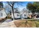 Charming white cottage-style home featuring a covered porch and a long driveway at 1547 Melrose Sw Dr, Atlanta, GA 30310