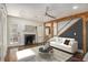 Living room featuring hardwood floors, fireplace, modern ceiling fan and view to dining room at 1547 Melrose Sw Dr, Atlanta, GA 30310