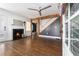 Living room featuring hardwood floors, fireplace, modern ceiling fan and view to front entry at 1547 Melrose Sw Dr, Atlanta, GA 30310