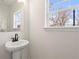 Bathroom featuring a pedestal sink, stylish black faucet, and a bright window for natural light at 1991 Hollywood Nw Rd # 14, Atlanta, GA 30318