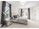 Bedroom featuring carpet, two bright windows dressed in elegant gray curtains and tufted headboard at 1991 Hollywood Nw Rd # 14, Atlanta, GA 30318