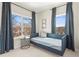 Bright bedroom features a large window dressed with elegant blue curtains, along with a sleek modern daybed at 1991 Hollywood Nw Rd # 14, Atlanta, GA 30318