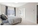 Bedroom with neutral walls and carpet, and a large window with gray curtains at 1991 Hollywood Nw Rd # 14, Atlanta, GA 30318