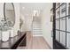 Inviting entryway featuring light wood floors, console table decor, and a staircase leading to the upper level at 1991 Hollywood Nw Rd # 14, Atlanta, GA 30318