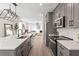 Modern kitchen with gray cabinets, white backsplash, stainless appliances and view into the living room at 1991 Hollywood Nw Rd # 14, Atlanta, GA 30318