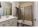 Well-lit bathroom features a vanity with solid surface countertop and a walk-in shower at 5635 Mirror Lake Dr, Cumming, GA 30028