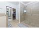 Main bathroom featuring a glass-enclosed shower with a tiled surround and a walk-in closet at 5635 Mirror Lake Dr, Cumming, GA 30028