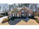 Beautiful brick home featuring manicured landscaping, a symmetrical design, and an attached two car garage at 845 Saint Marks Walk, Suwanee, GA 30024