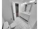 Bathroom featuring double sink vanity, marble floor and neutral wall color at 1235 Park Pass Way, Suwanee, GA 30024