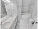 Bright bathroom featuring double sink vanity, tile floors and a soaking tub with marble style tile at 1235 Park Pass Way, Suwanee, GA 30024