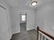 Neutral hallway features carpet and doorway to bedroom with natural light streaming in at 1235 Park Pass Way, Suwanee, GA 30024