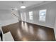 Elegant living room with hardwood floors, neutral color, large windows, and a fireplace at 1235 Park Pass Way, Suwanee, GA 30024