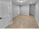 Bright living room featuring tile flooring, white front door and closet at 1235 Park Pass Way, Suwanee, GA 30024