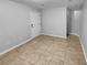 Bright living room featuring tile flooring and a white front door at 1235 Park Pass Way, Suwanee, GA 30024