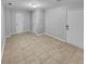 Bright living room featuring tile flooring, white front door and closet at 1235 Park Pass Way, Suwanee, GA 30024